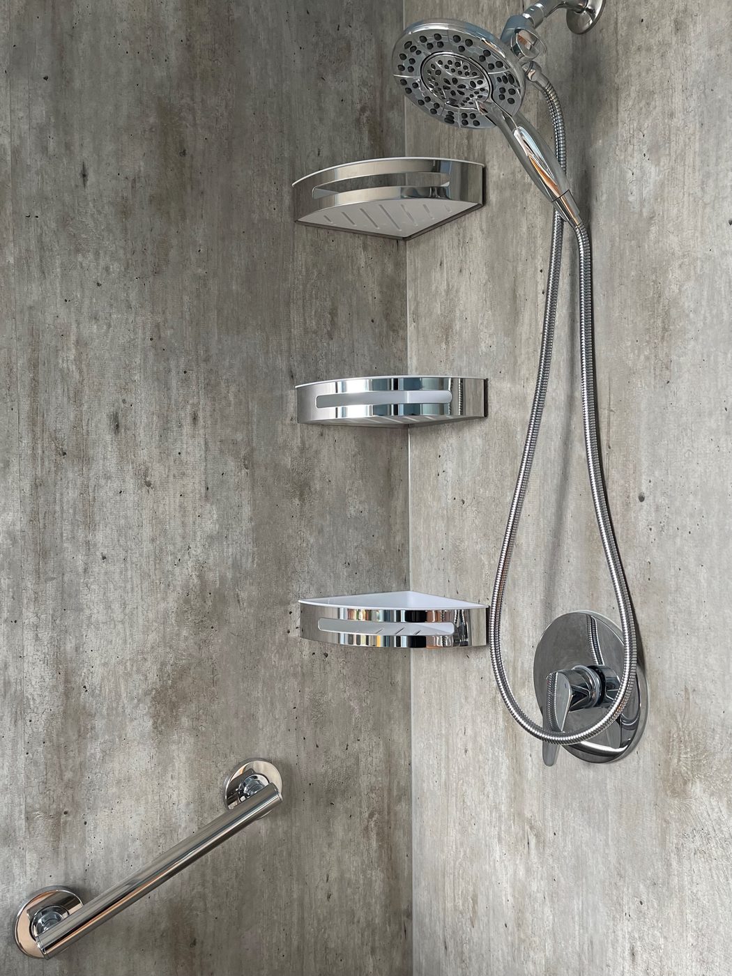 A walk-in shower with concrete-look waterproof walls